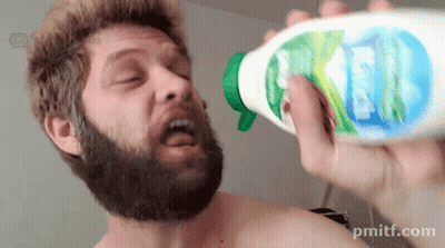A Shirtless Man With A Beard Is Holding A Bottle Of Kleenex In His Right Hand GIF