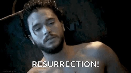 A Shirtless Man With A Beard Is Laying In A Chair With The Words Resurrection Written On The Screen . GIF