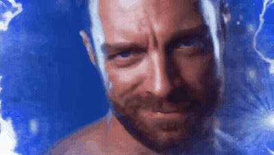 A Shirtless Man With A Beard Is Looking At The Camera With A Blue Background Behind Him . GIF