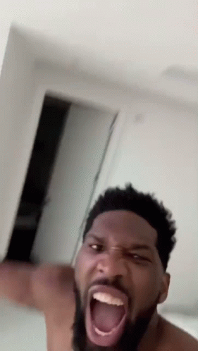 A Shirtless Man With A Beard Is Making A Funny Face GIF