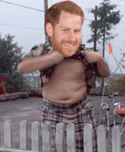 A Shirtless Man With A Beard Is Standing Behind A Fence GIF