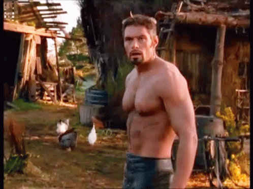Shirtless Man With Beard In Front Of Chicken Coop GIF