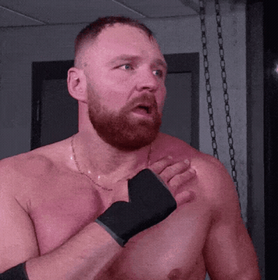 A Shirtless Man With A Beard Is Wearing Boxing Gloves On His Hands GIF