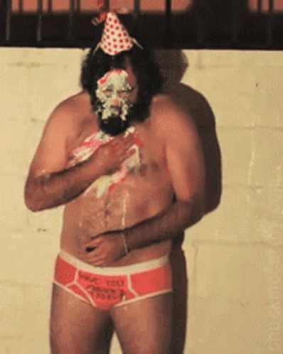 A Shirtless Man With A Birthday Cake On His Face Is Wearing Underwear That Says Have You Tried GIF