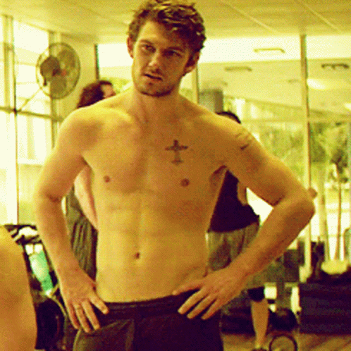 A Shirtless Man With A Cross On His Chest GIF
