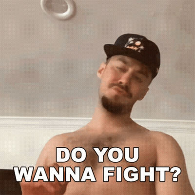 A Shirtless Man With A Hat Says Do You Wanna Fight GIF