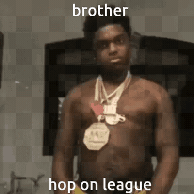 A Shirtless Man With A Medal Around His Neck Is Standing In Front Of A Window . GIF