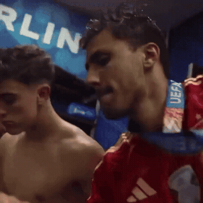 A Shirtless Man With A Medal Around His Neck That Says Uefa On It GIF