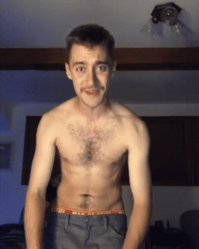 A Shirtless Man With A Mustache Is Wearing A Pair Of Underwear That Says Mail Of America GIF