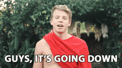 A Shirtless Man With A Red Scarf Around His Shoulders Says Guys It 'S Going Down GIF