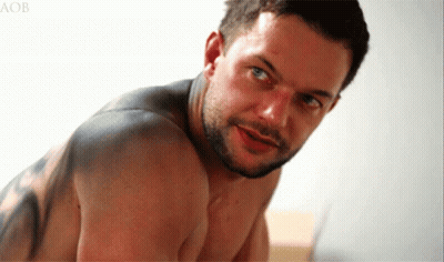 A Shirtless Man With A Tattoo On His Back Looks At The Camera With The Letters Aob Behind Him GIF