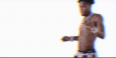 A Shirtless Man With A Tattoo On His Chest Is Wearing Black Underwear GIF