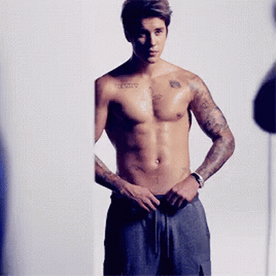 A Shirtless Man With A Tattoo On His Chest That Says ' Infinity ' GIF