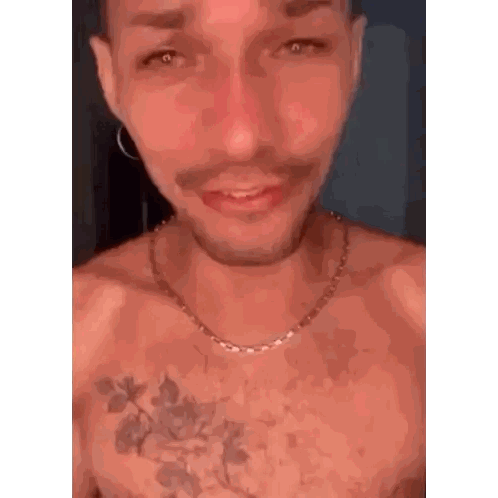 A Shirtless Man With A Tattoo On His Chest Wearing A Necklace . Sticker
