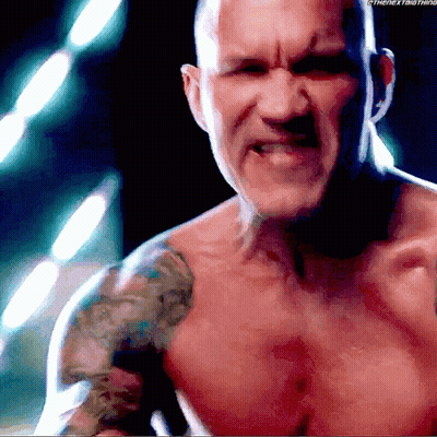 A Shirtless Man With A Tattoo On His Shoulder Is Looking At The Camera GIF