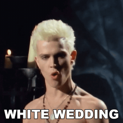 A Shirtless Man With Blonde Hair Is Singing A Song Called White Wedding GIF