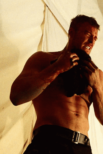 A Shirtless Man With Blood On His Face Is Holding A Black Cloth GIF