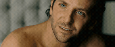 A Shirtless Man With Blue Eyes And A Beard Looks At The Camera GIF