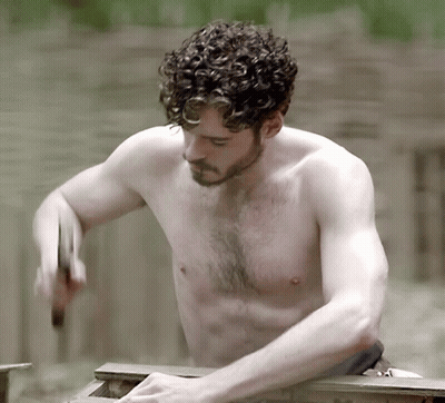 A Shirtless Man With Curly Hair Is Hammering Something GIF