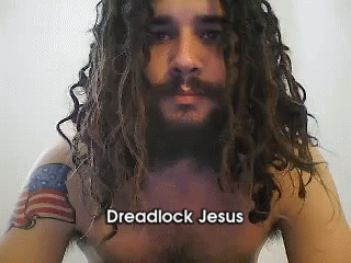 A Shirtless Man With Dreadlocks And A Tattoo On His Arm Has The Name Dreadlock Jesus On His Chest GIF