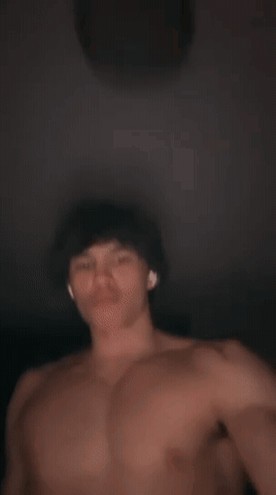 A Shirtless Man With Ear Buds On His Ears GIF