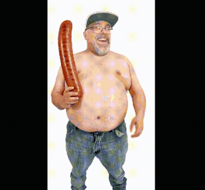 A Shirtless Man With Glasses And A Hat Is Holding A Long Sausage GIF