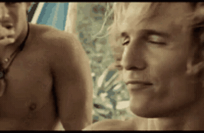 A Shirtless Man With His Eyes Closed Is Standing Next To Another Shirtless Man With His Eyes Closed . GIF