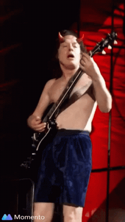 A Shirtless Man With Horns Playing A Guitar GIF