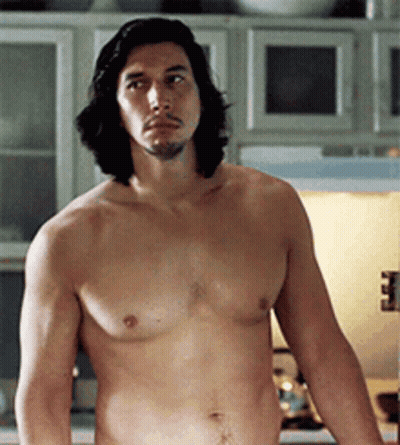 A Shirtless Man With Long Hair And A Beard Is Standing In A Kitchen GIF