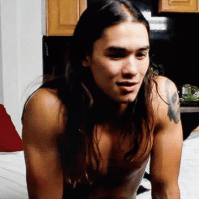 A Shirtless Man With Long Hair And A Tattoo On His Chest GIF
