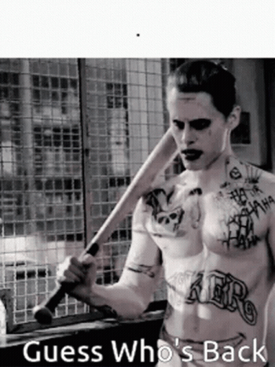 A Shirtless Man With Tattoos Is Holding A Baseball Bat And The Caption Guess Who 'S Back GIF