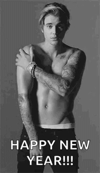 A Shirtless Man With Tattoos On His Arms Is Standing In A Black And White Photo And Wishing A Happy New Year . GIF