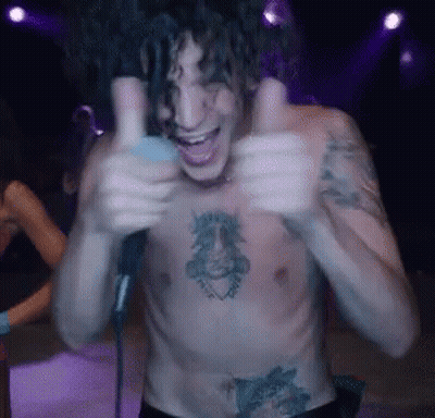 A Shirtless Man With Tattoos On His Chest Is Giving Two Thumbs Up GIF