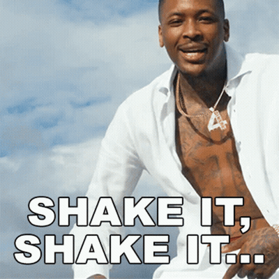 A Shirtless Man With The Words Shake It Shake It Written Below Him GIF