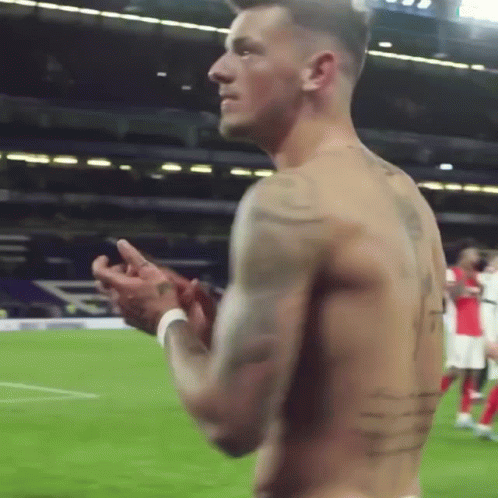 A Shirtless Soccer Player Is Clapping His Hands On The Field GIF