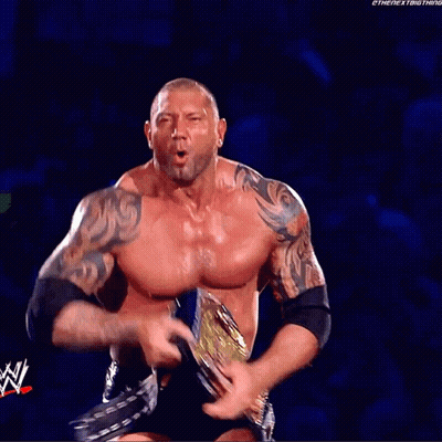 A Shirtless Wrestler Holds A Wrestling Championship While Wearing A Green Belt That Says ' Smackdown ' GIF
