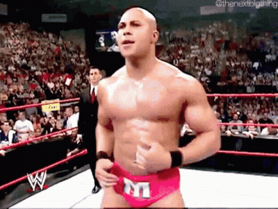 A Shirtless Wrestler In A Pink Underwear With The Letter M On It Is In A Wrestling Ring . GIF