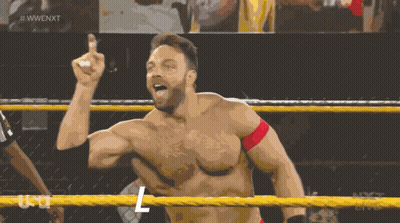 A Shirtless Wrestler In A Wrestling Ring With The Letters L On His Chest GIF