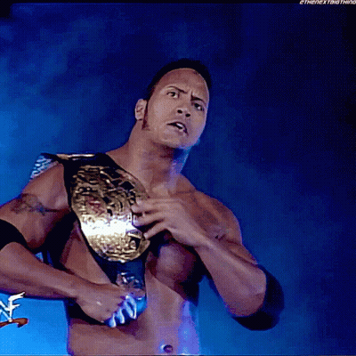 A Shirtless Wrestler Is Holding A Wrestling Championship Belt In His Right Hand GIF
