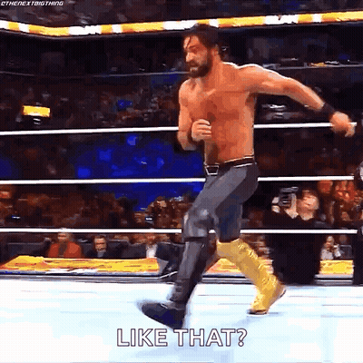 A Shirtless Wrestler Is Jumping In The Air In A Wrestling Ring While Saying `` Like That '' . GIF