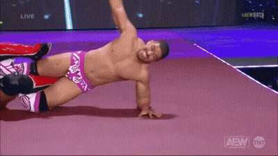 A Shirtless Wrestler Is Laying On The Floor During A Live Aew Event GIF