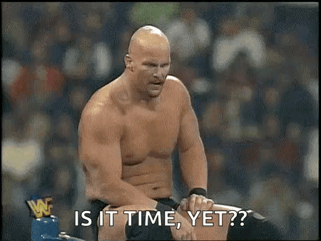 A Shirtless Wrestler Is Sitting In A Boxing Ring With The Words `` Is It Time , Yet ? '' GIF