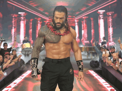 A Shirtless Wrestler Is Walking Down A Ramp With A Crowd Watching GIF