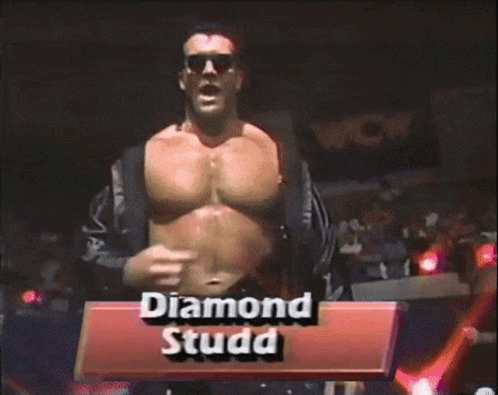 A Shirtless Wrestler Named Diamond Studd Stands In Front Of A Crowd GIF