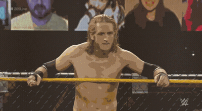 A Shirtless Wrestler Stands In A Wrestling Ring With The Letters W On The Bottom Right GIF