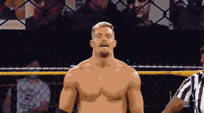 A Shirtless Wrestler Stands In Front Of A Referee In A Cage With The Hashtag # 2K20live GIF