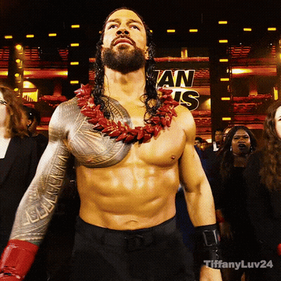 A Shirtless Wrestler Stands In Front Of A Sign That Says ' An Is ' On It GIF