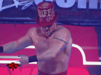 A Shirtless Wrestler Wearing A Red Top Hat With The Word Rules Written On It GIF