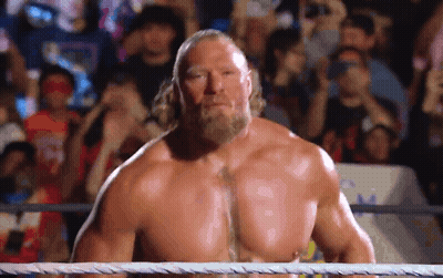 A Shirtless Wrestler With A Beard Is Standing In A Wrestling Ring . GIF