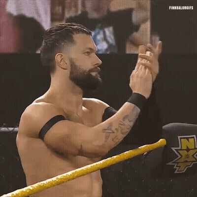 A Shirtless Wrestler With A Beard Is Standing In A Wrestling Ring Clapping His Hands . GIF